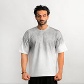 Man wearing a plain white t-shirt against a light gray background