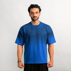 Man wearing a blue t-shirt against a plain background
