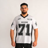 A man modeling a white and black athletic jersey with 'REXEZ' and the number '71' printed on the front, set against a plain light gray background.