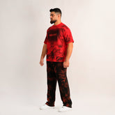 Man wearing a red and black tie-dye outfit with 'REXIEZ' branding on a white background
