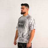 Man wearing a gray t-shirt with 'REXEE' logo on a white background
