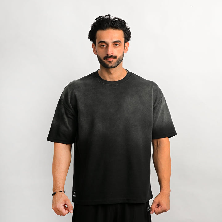 Man wearing a black t-shirt against a plain background