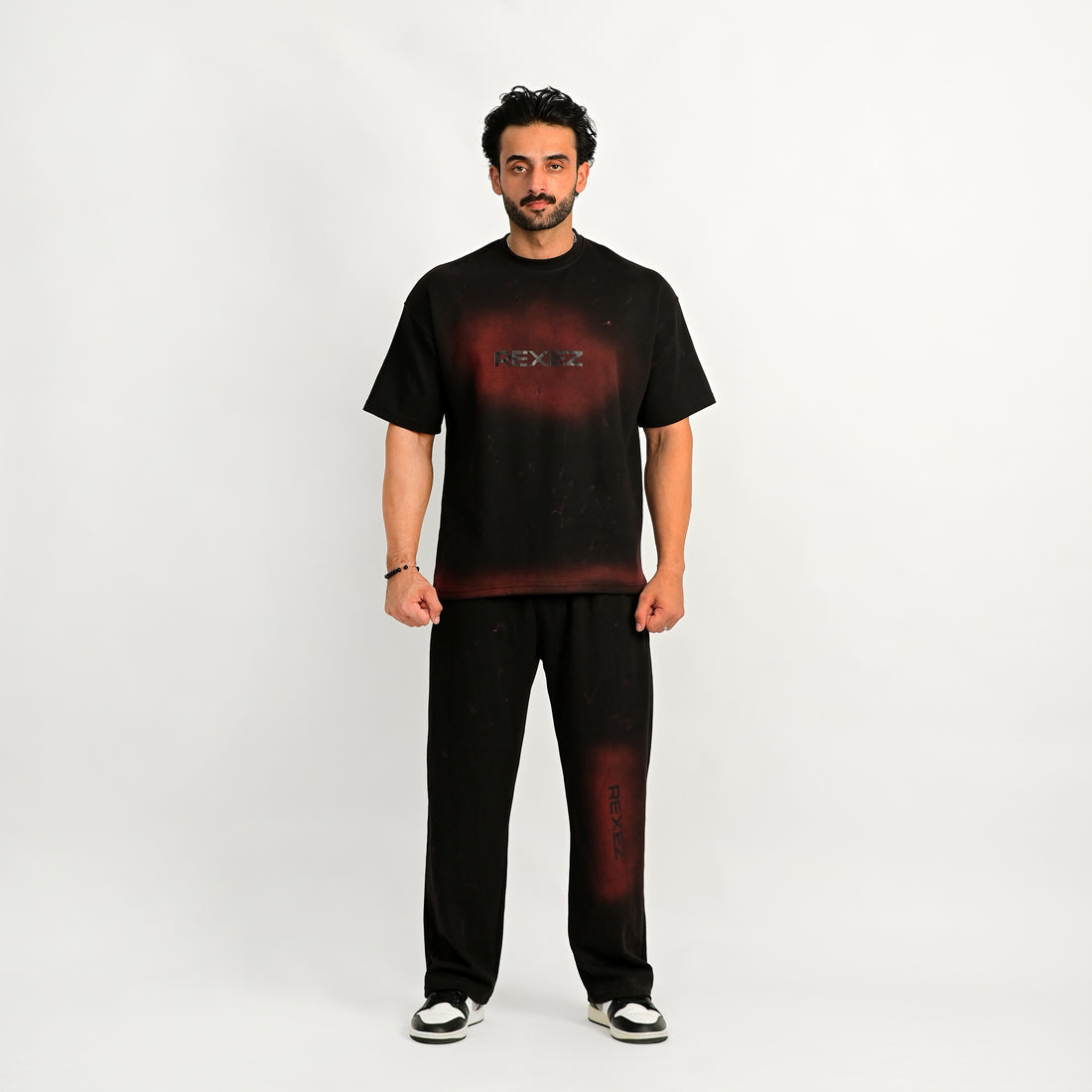 Man wearing a black t-shirt with a red graphic and text on a white background