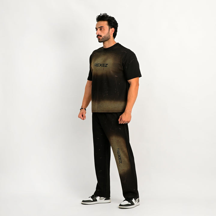 Man wearing a black t-shirt and pants with 'REXEEZ' branding on a white background