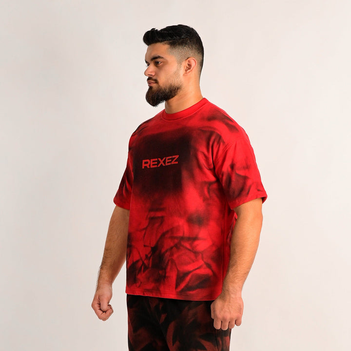 Man wearing a red and black tie-dye outfit with 'REXIEZ' branding on a white background